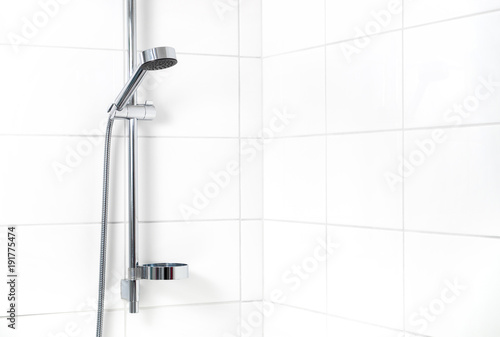 Modern shower with white wall tiles. Simple stylish Scandinavian home interior design. Clean fresh bathroom.