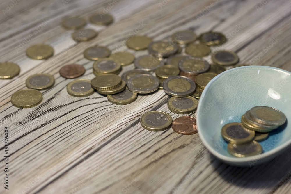 Coins on the table. Rough boards background. Money concept. Closeup Coins on the table. Rough boards background. Money concept. Closeup