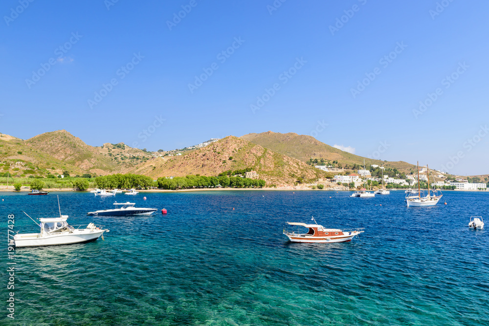 Picturesque Bay with clear blue water, yachts and fishing boats. Grikos Bay, Patmos island, Dodecanese Islands, Greece.