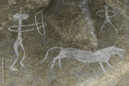 A hunting scene of an ancient man on a wild animal on a cave wall.