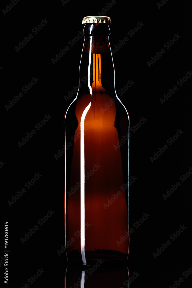 Closed bottle of beer on a black background. Closed bottle of beer on a black background.