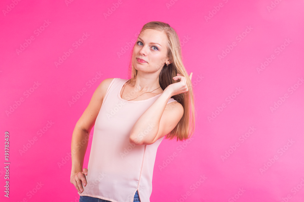 Beautiful blonde girl portrait with hands for cosmetic concept over pink background. Beautiful blonde girl portrait with hands for cosmetic concept over pink background.