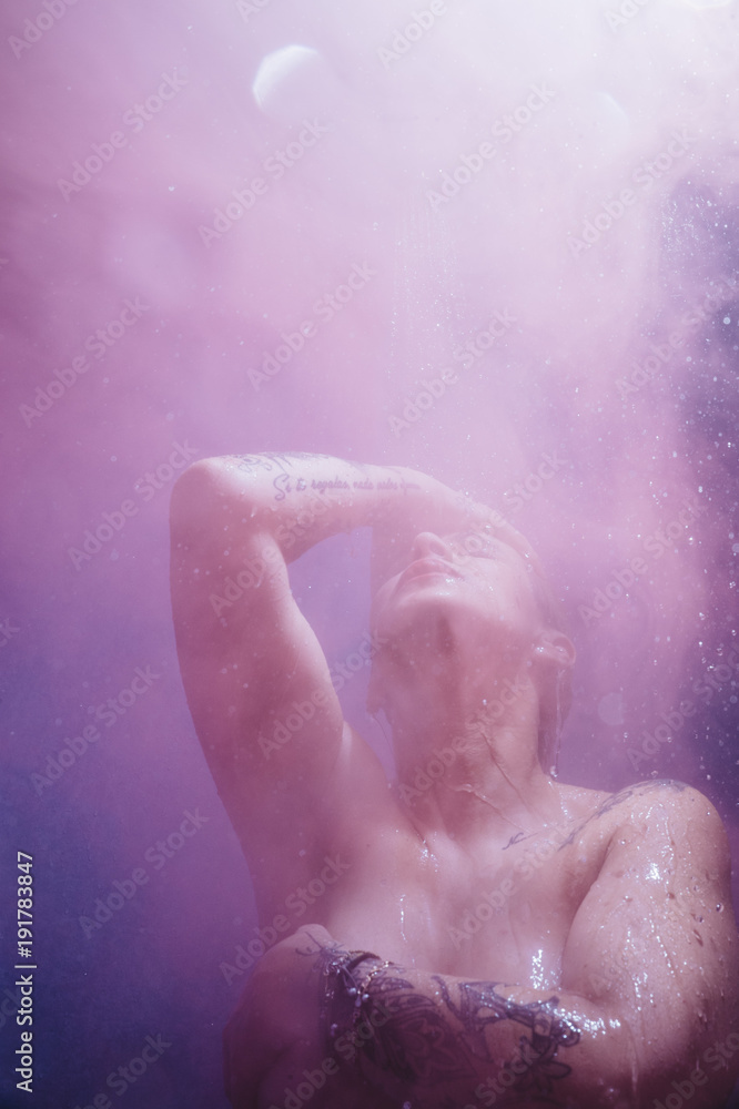 woman in shower with colorful steam woman in shower with colorful steam
