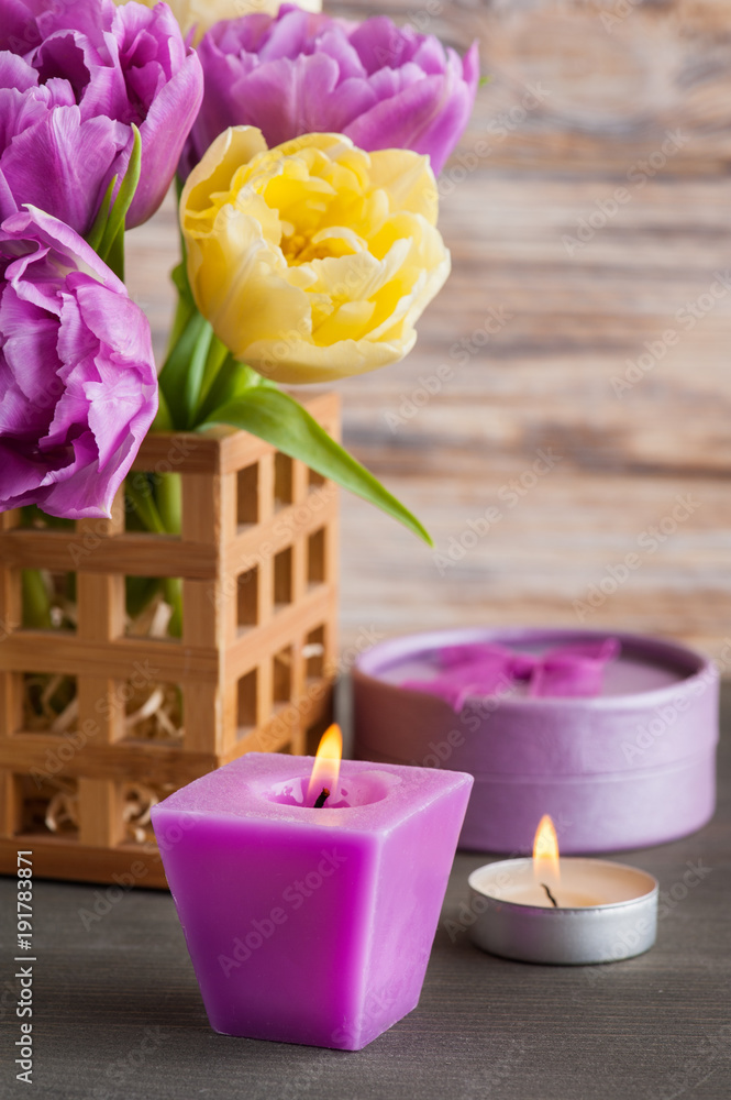 Purple yellow tulip flower, lit candles Purple yellow tulip flower, lit candles