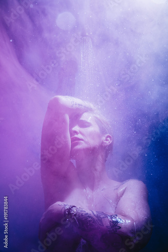 woman in shower with colorful steam