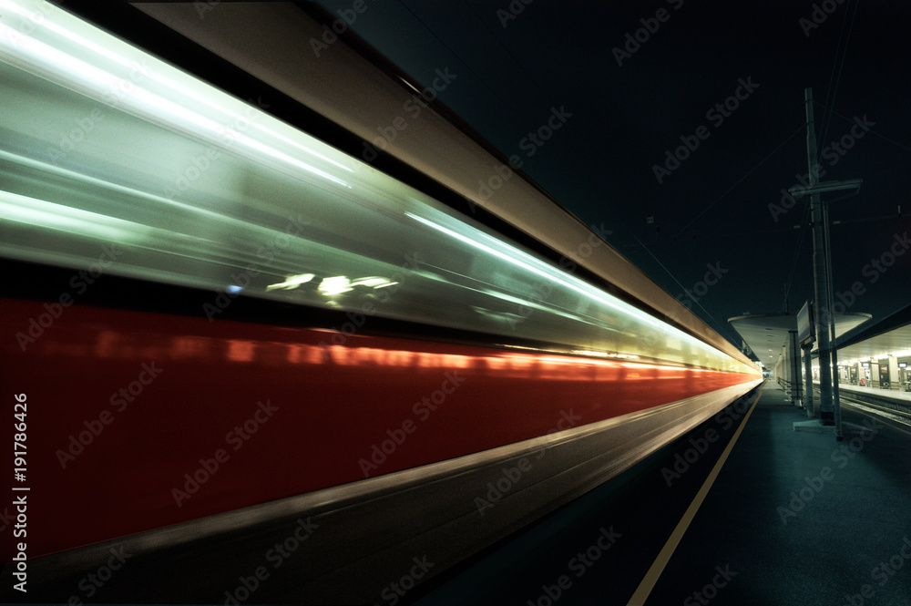 blurred motion of the night red-grey train