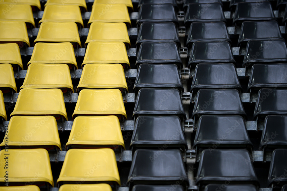 Obraz premium gelb schwarz Sitzreihen im Stadion
