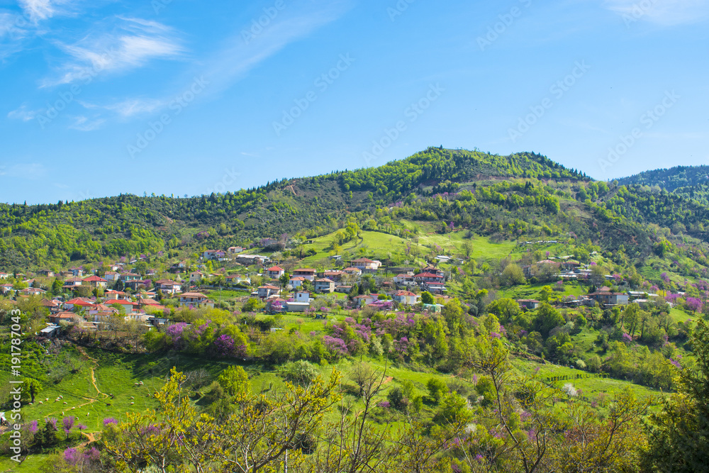 Spring colors and traditional greek village at the picturesque mountains landscape near lake Plastiras, Greece, Europe.