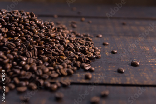 roasted coffee beans on dark wooden table