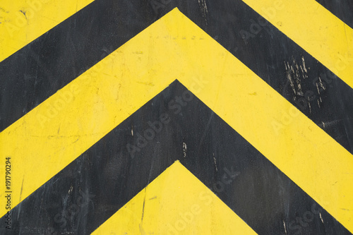 Black and yellow steel surface of industrial equipment. Warning or danger pattern. © abyrvalg_00