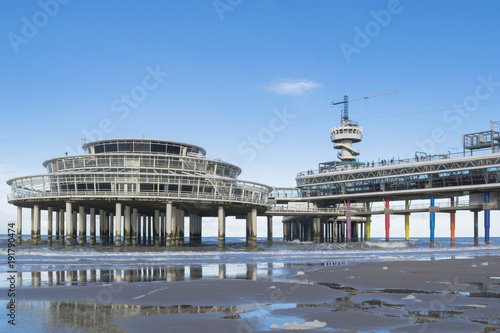 Low tide of North Sea with details of pier at Scheveningen beach near the Hague, Netherlands. arkhitiektura zodchiestvo архитектура зодчество fon fone fonovyi riezhim kontiekst photo