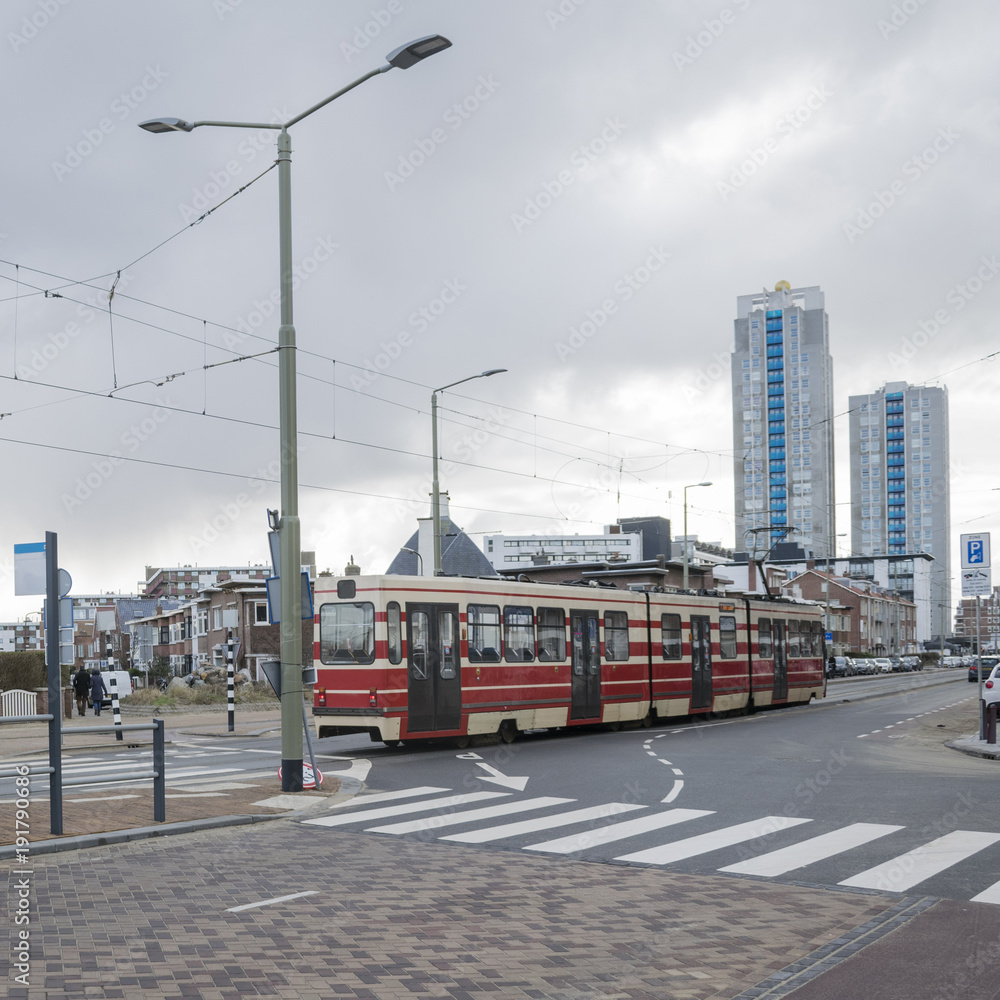 Details of street infrastructure with pedestrian crossing and bicycle lane and tram car crossing street in the Hague, Netherlands. 