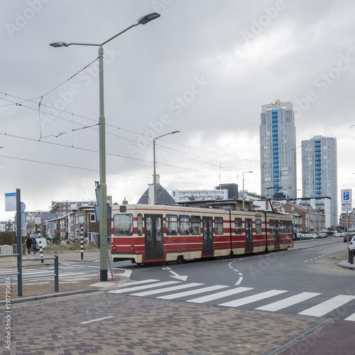 Details of street infrastructure with pedestrian crossing and bicycle lane and tram car crossing street in the Hague, Netherlands.  © abyrvalg_00