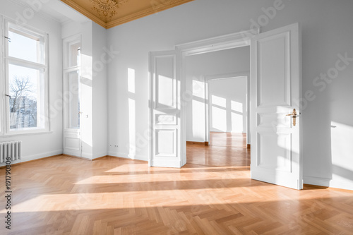 Empty room, flat with stucco ceiling ,  parquet floor and white walls  photo