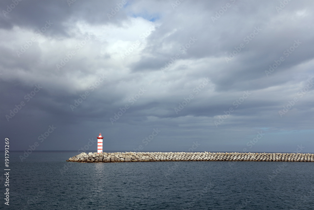 Lighthouse against a stormy sky background