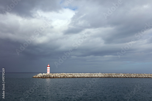 Lighthouse against a stormy sky background © Rechitan Sorin