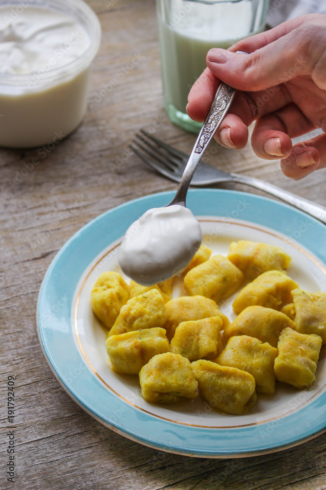 gnocchi in a plate on a wooden table gnocchi in a plate on a wooden table