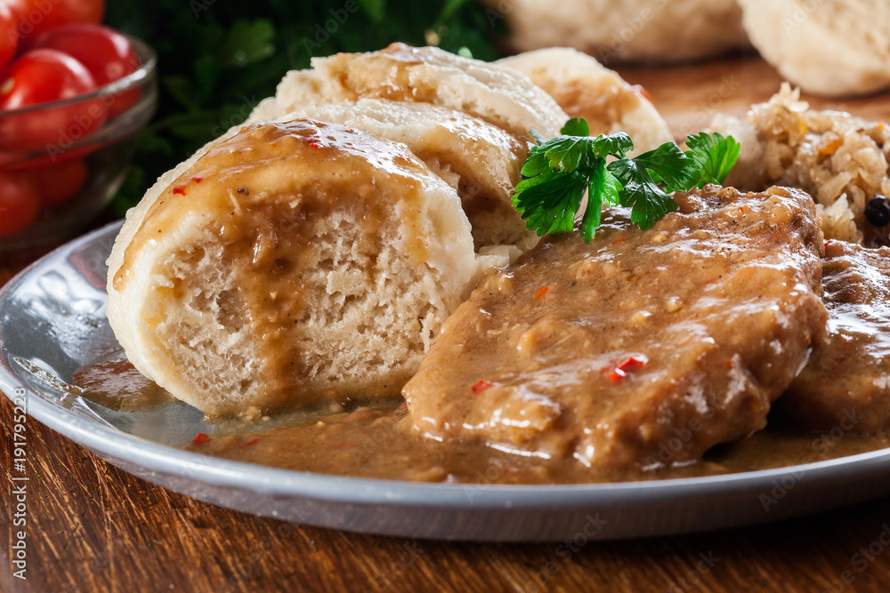 Pork loin in gravy with bread dumplings and sauerkraut Pork loin in gravy with bread dumplings and sauerkraut