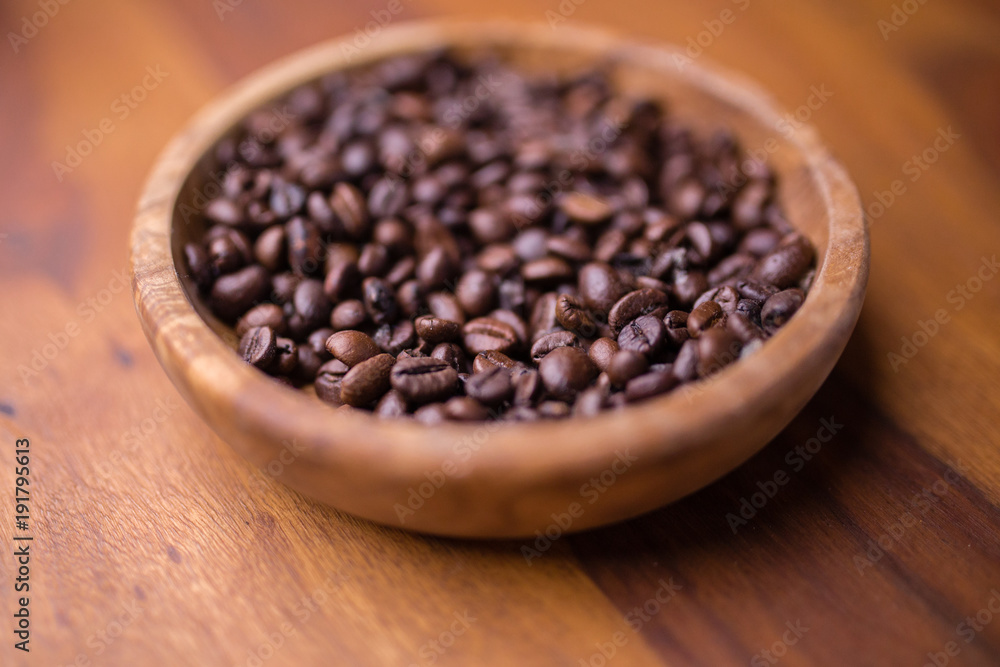 A plate of beans coffee on a wooden table