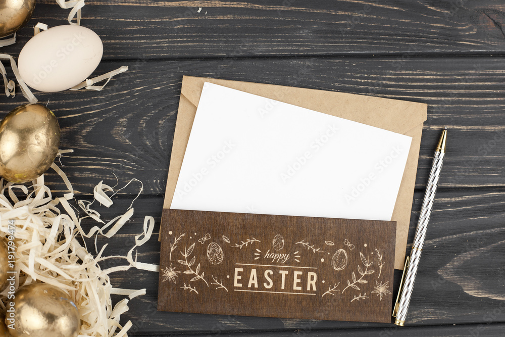 Easter concept.Flat lay  with gold eggs and greeting card