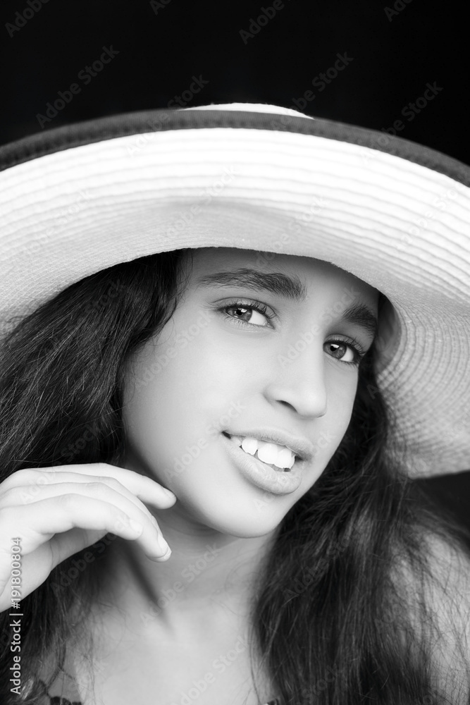 Portrait of a young african american girl laughing with sun hat Portrait of a young african american girl laughing with sun hat