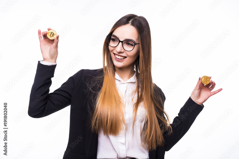 Young successful confident woman with glasses holds a bitcoin in her hand isolated on white background Young successful confident woman with glasses holds a bitcoin in her hand isolated on white background