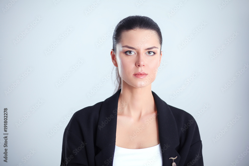 Young woman standing, isolated on gray background Young woman standing, isolated on gray background