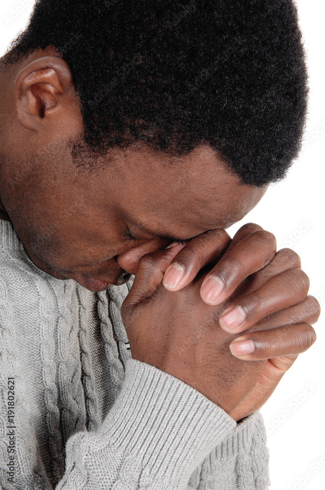 Fototapeta premium Praying African man with his hands folded