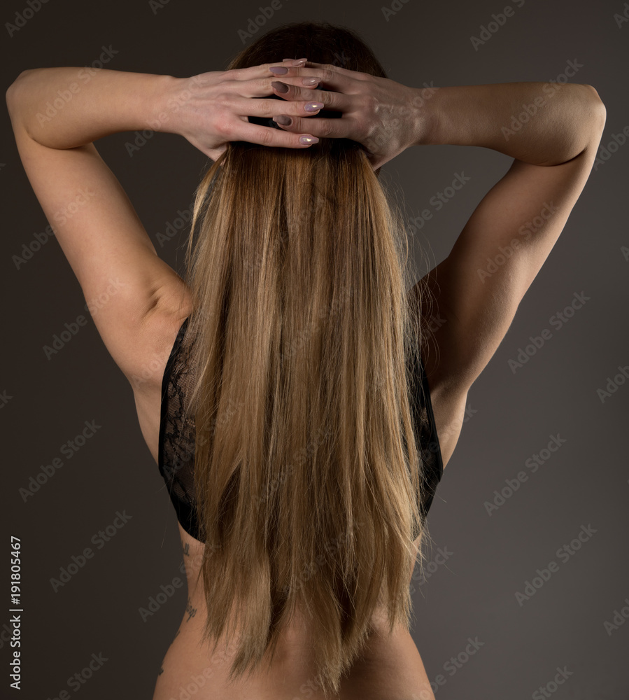 Boudoir photography of a beautiful young woman over dark background Boudoir photography of a beautiful young woman over dark background