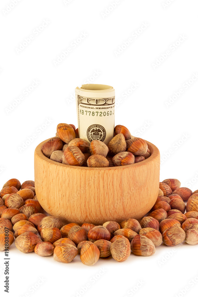Nuts of hazelnuts money dollars on white background. The concept of profit money from the harvest of hazelnuts Nuts of hazelnuts money dollars on white background. The concept of profit money from the harvest of hazelnuts