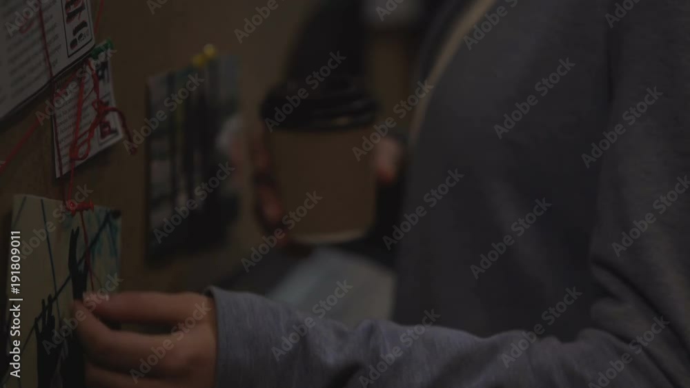 Private agent wrapping red stripe around the pin on investigation board, answer Private agent wrapping red stripe around the pin on investigation board, answer