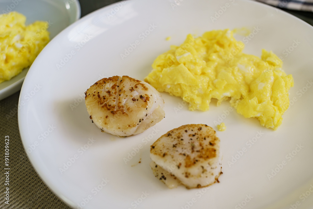 Close up shot of fry scallops and eggs