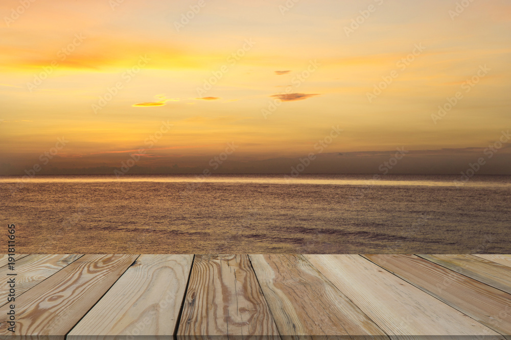 Landscape sunrise and golden light in the sea with wooden space.
