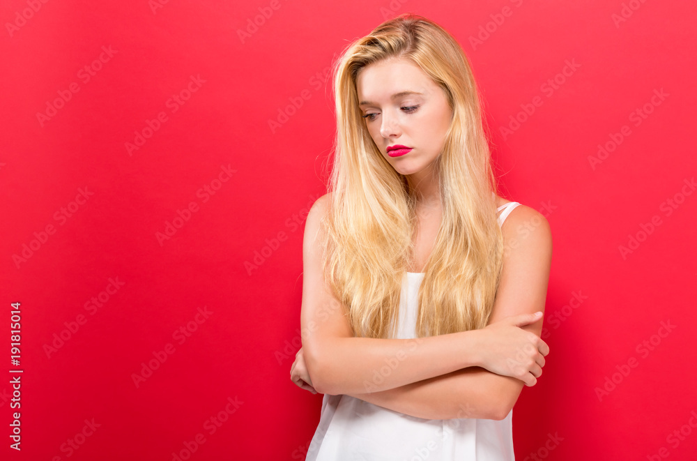 Fototapeta premium Unhappy young woman on a solid background
