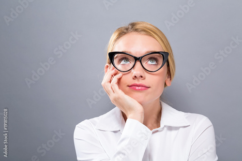 Young businesswoman in a thoughtful pose on a solid background
