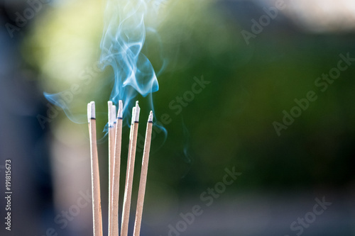 burning Embossed  sticks and smoke from incense burning and smoke