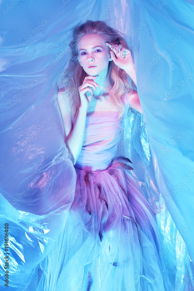 Fashion portrait of young beautiful woman in fluffy violet dress. Fashion portrait of young beautiful woman in fluffy violet dress.