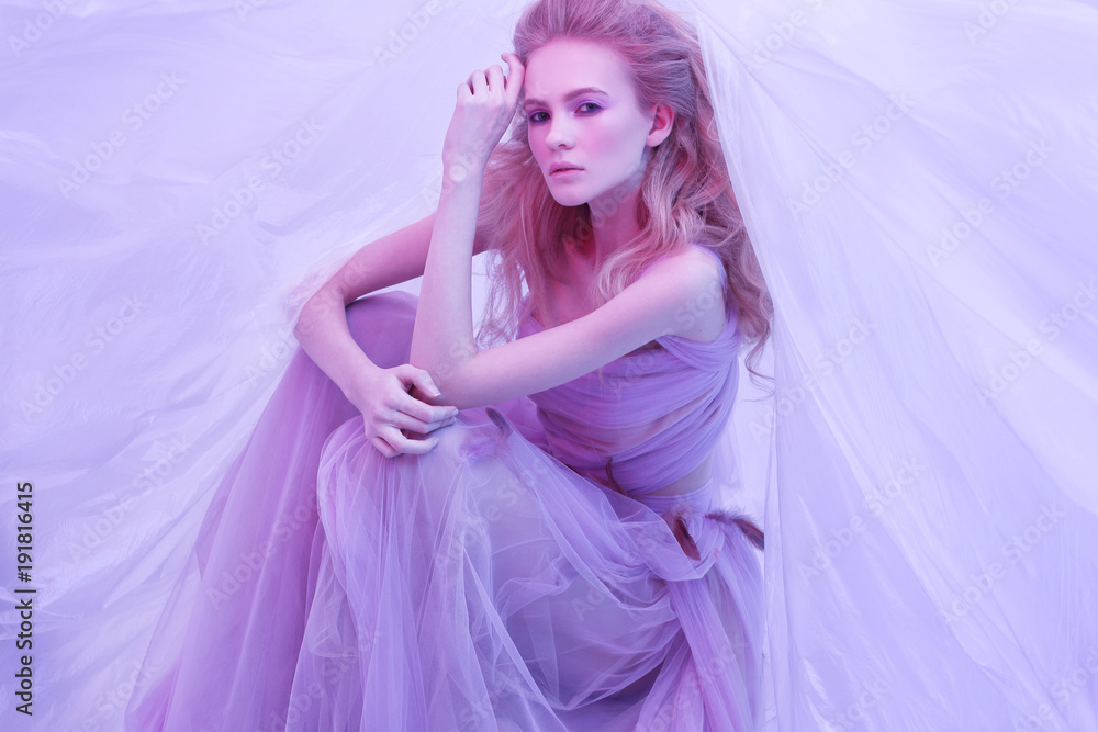 Fashion portrait of young beautiful woman in fluffy violet dress. Fashion portrait of young beautiful woman in fluffy violet dress.