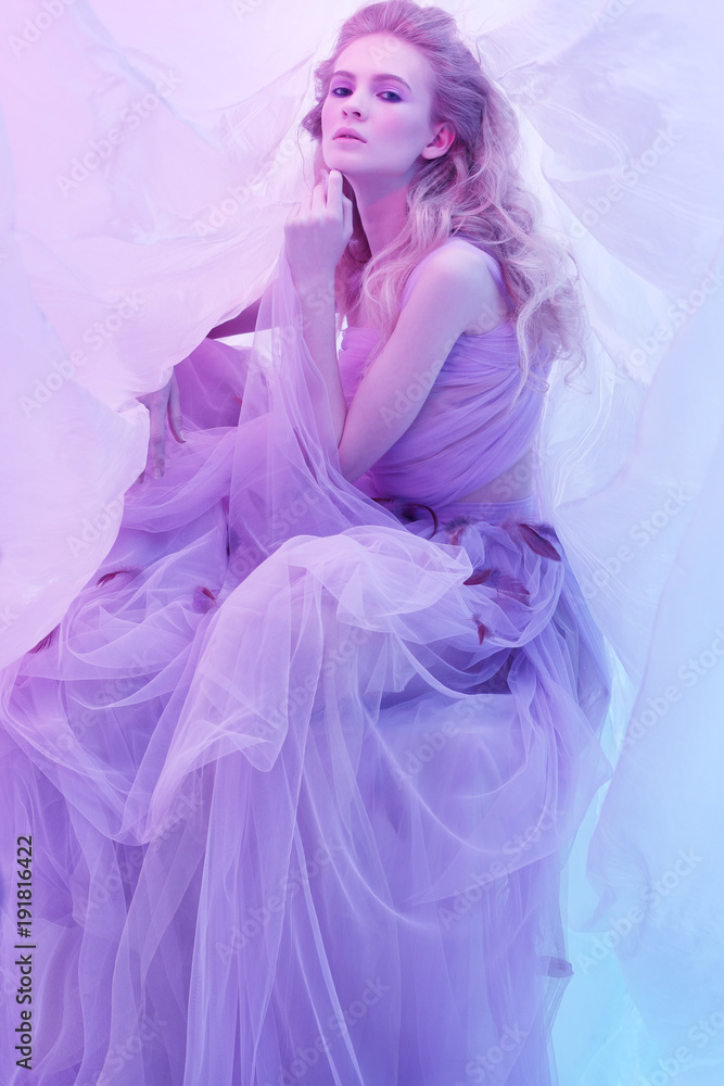 Fashion portrait of young beautiful woman in fluffy violet dress. Fashion portrait of young beautiful woman in fluffy violet dress.