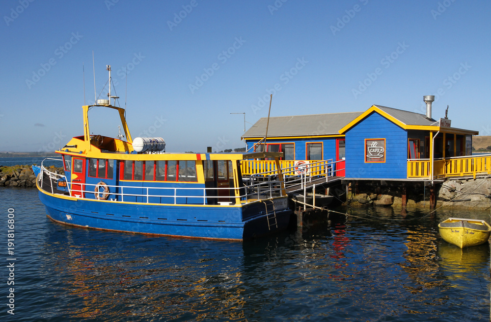 Bright bue and yellow boat against a blue and yellow building Bright bue and yellow boat against a blue and yellow building