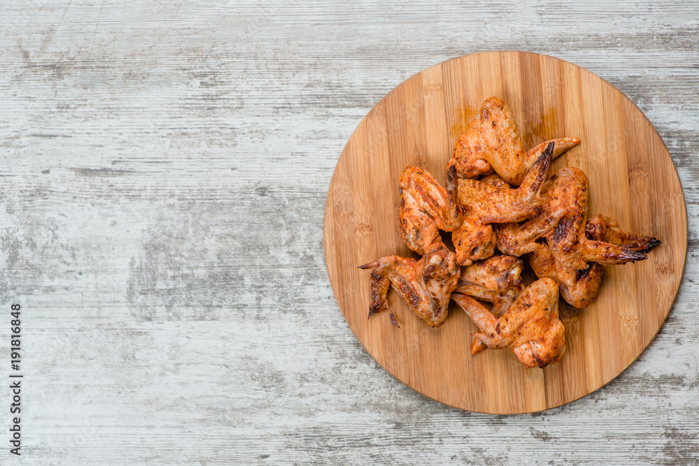 Tasty grilled chicken wings. Top view. Space for text