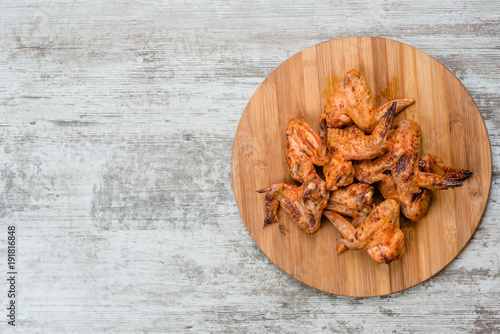 Tasty grilled chicken wings. Top view. Space for text