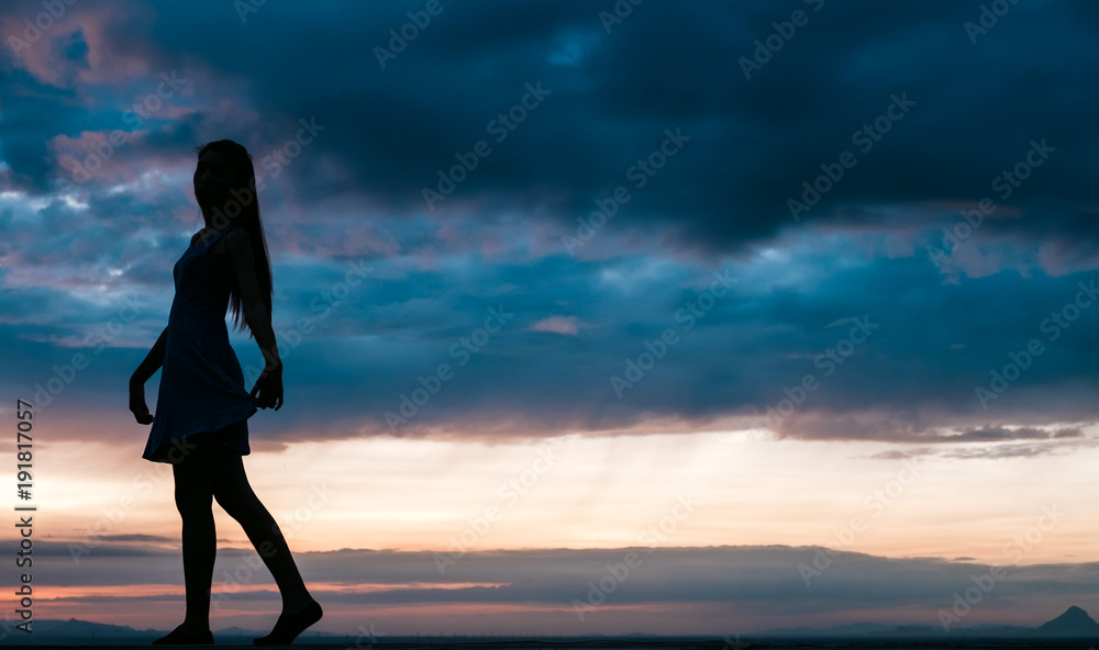 Fototapeta premium Young woman relaxing in summer sunset sky outdoor. People freedom style.
