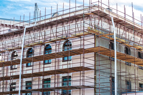 Photography scaffolding on wall of the building for restoration work and renovation of facad