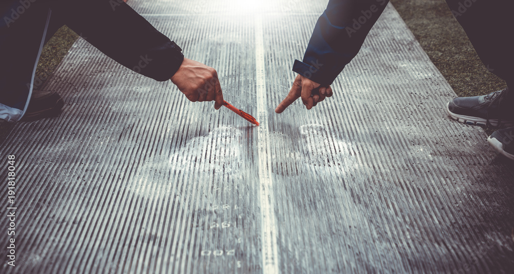 Long jump measuring by two judges. Sports day competition activities