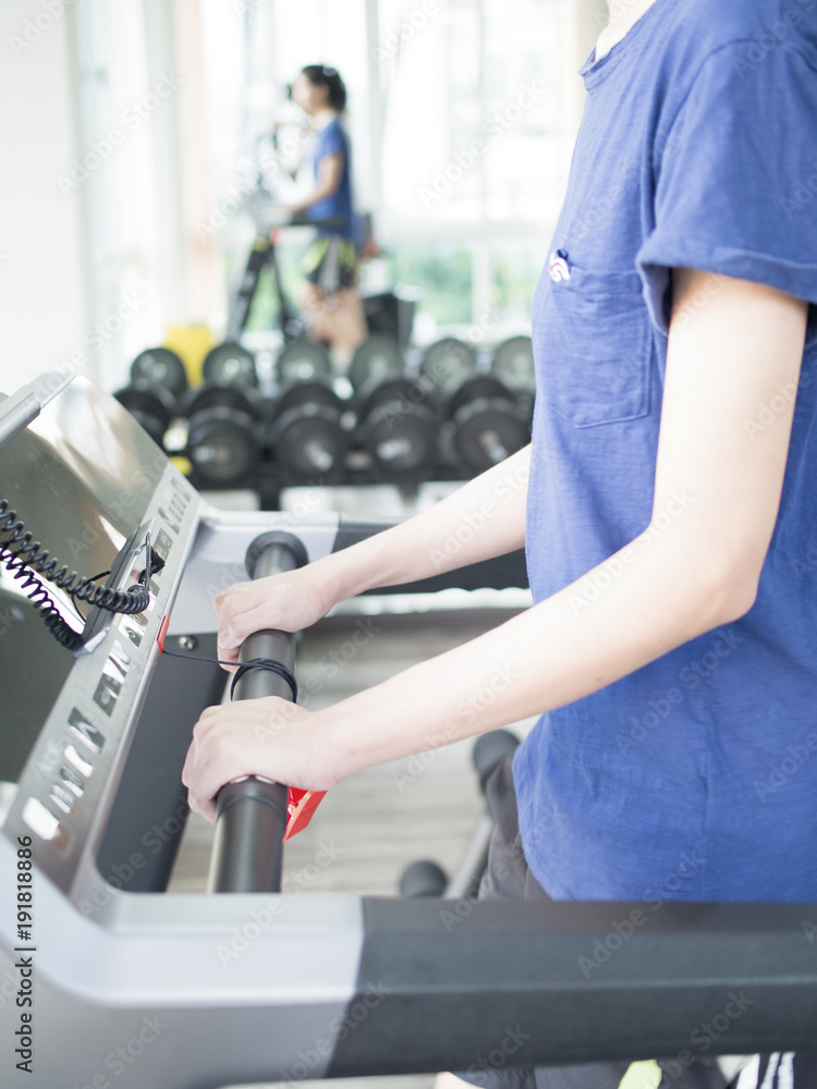 Girl is running on treadmill. Close up shot on upper body. Girl is running on treadmill. Close up shot on upper body.