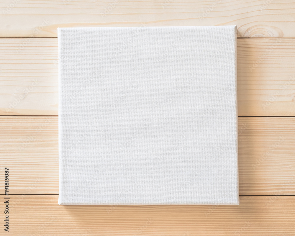White blank canvas mockup square size on wood wall for arts painting and photo hanging interior decoration White blank canvas mockup square size on wood wall for arts painting and photo hanging interior decoration