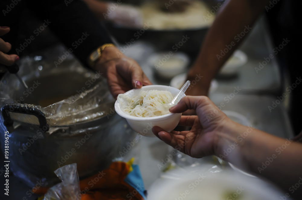 Feeding the poor to hands of a beggar. Poverty concept Feeding the poor to hands of a beggar. Poverty concept