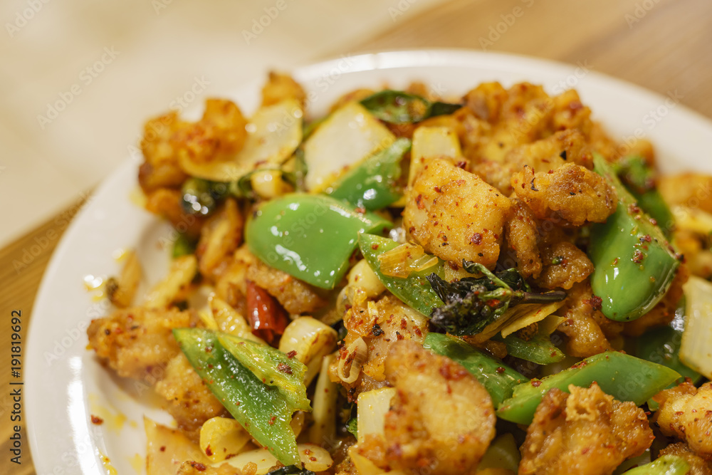 Close up shot of chicken with szechwan pepper and green pepper Close up shot of chicken with szechwan pepper and green pepper