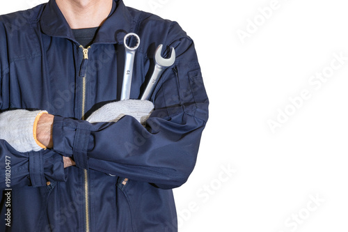 Car repairman wearing a dark blue uniform standing and holding a wrench that is an essential tool for a mechanic isolated on white background.